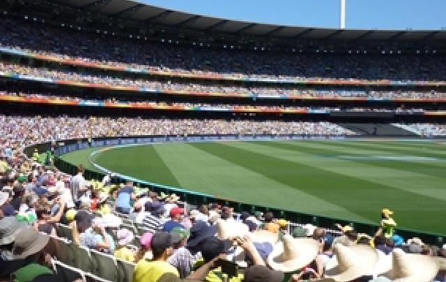 A photo showing a crowd and the grass at the Melbourne Cricket Ground on a sunny day