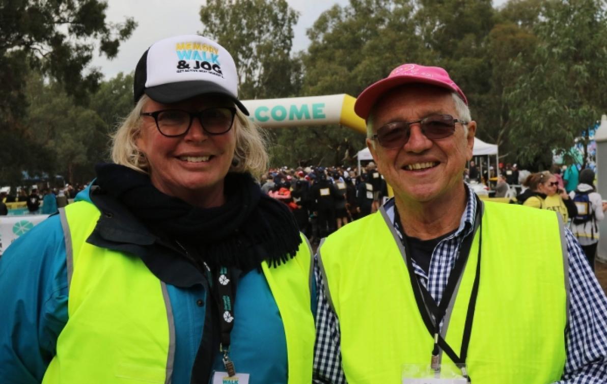 Liz Grogan and Chris Finley in hi-vis vests volunteering at the memory walk and jog event.