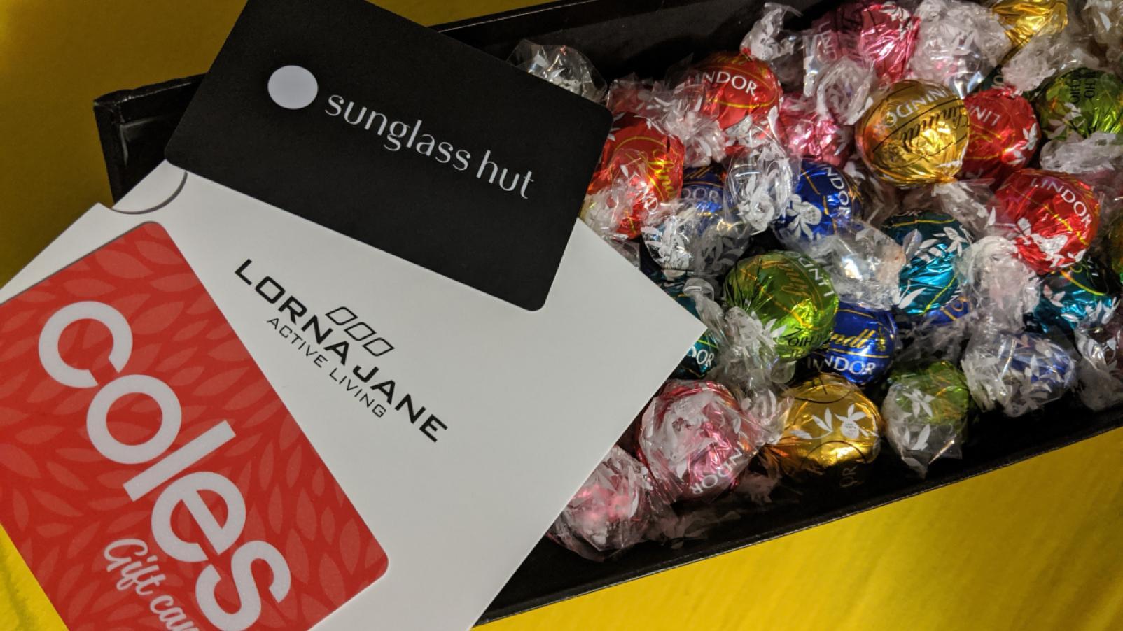 A box of Lindor chocolates, and gift cards from Coles, Lorna Jane and Sunglass Hut.