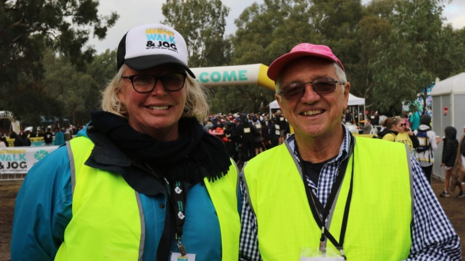 Liz Grogan and Chris Finley in hi-vis vests volunteering at the memory walk and jog event.