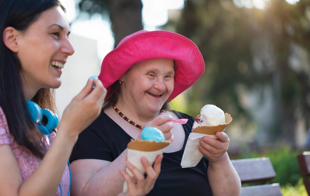 Two people eating ice-cream together: one appears to have an intellectual disability.