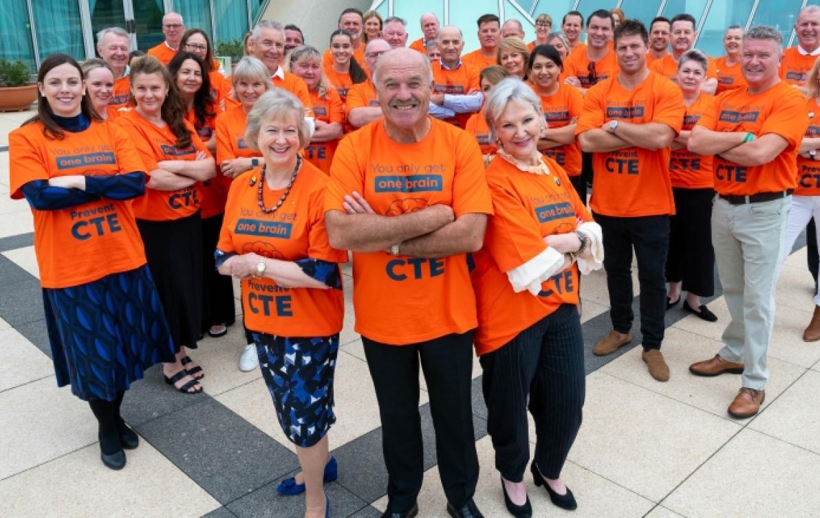 Advocates at Parliamentary Friends of Dementia event in February 2024, wearing orange t-shirts to promote CTE awareness.