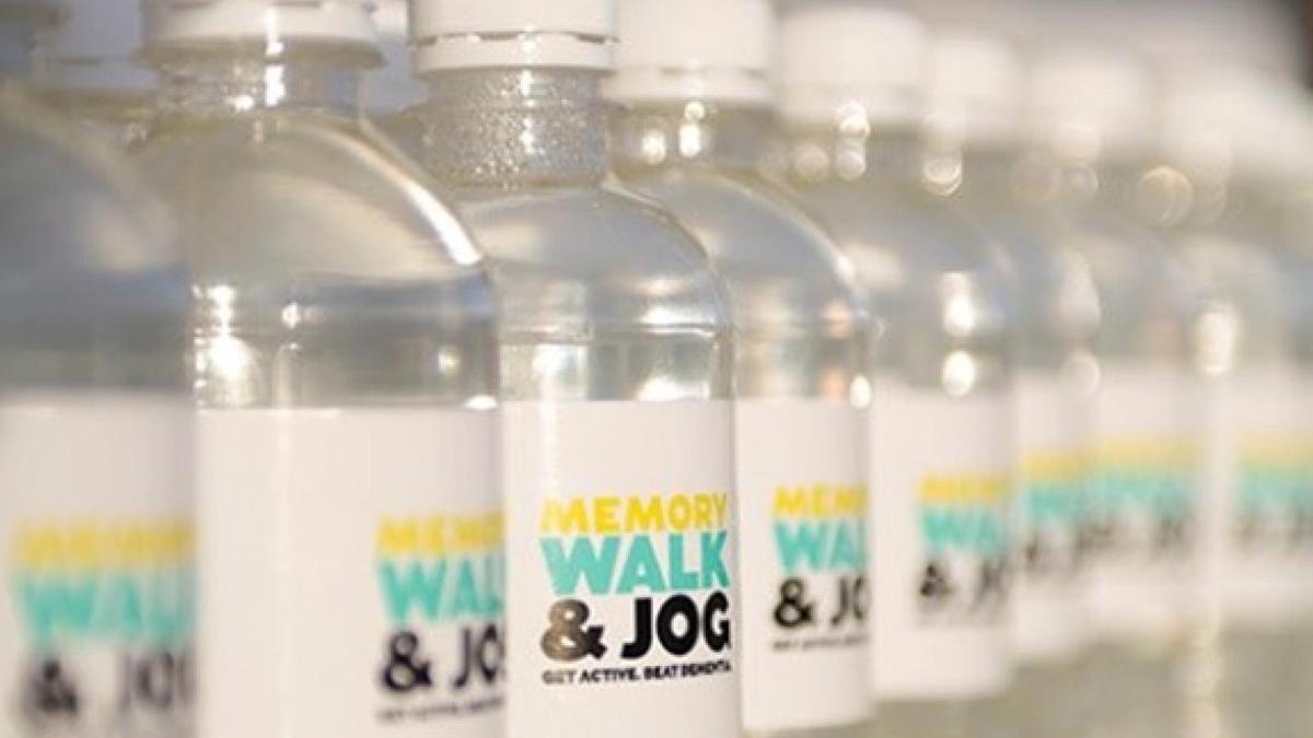 A row of plastic water bottles with Memory Walk and Jog labels