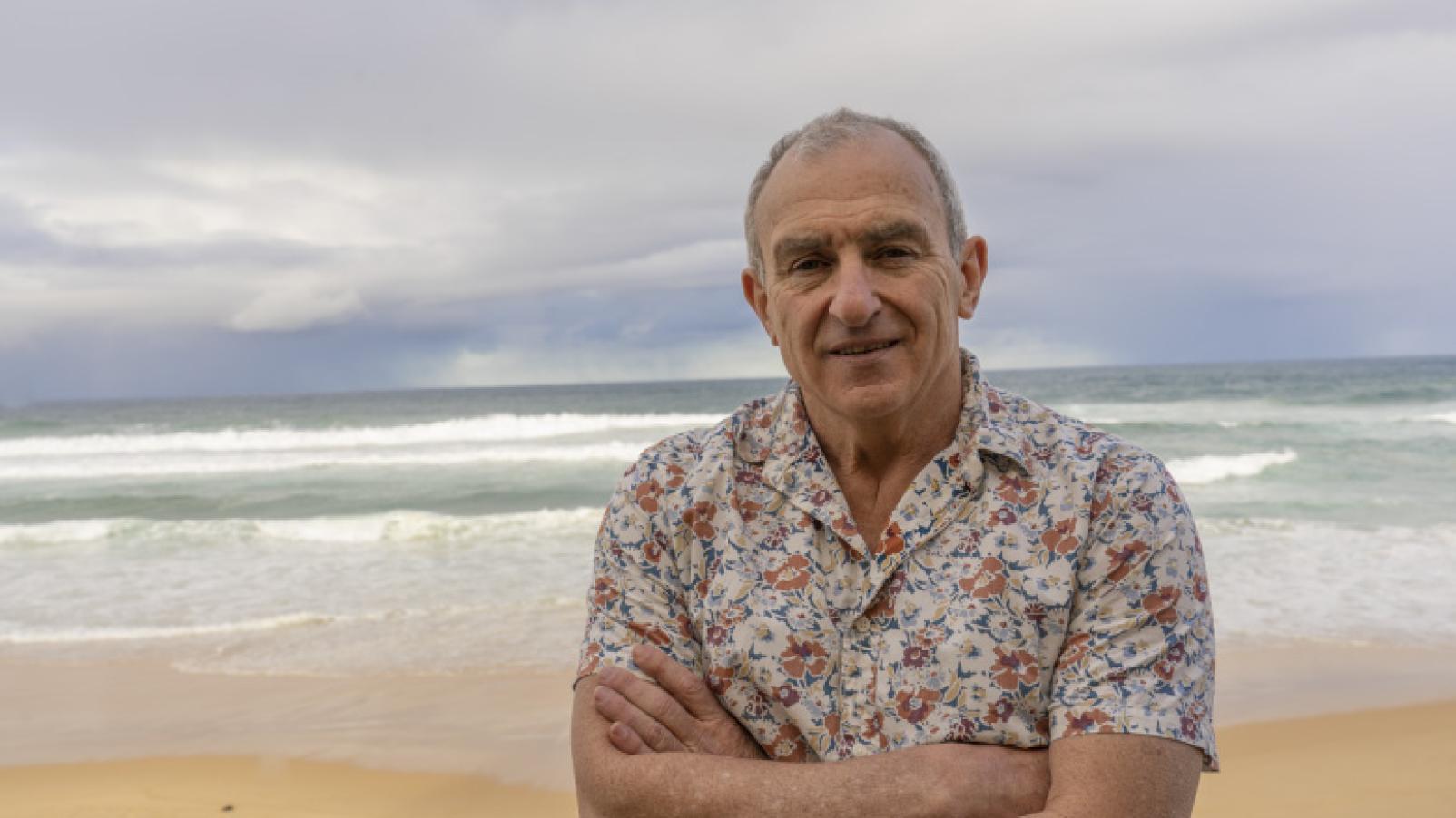 Dementia Advocate Bill Yeates portrait standing on a beach.
