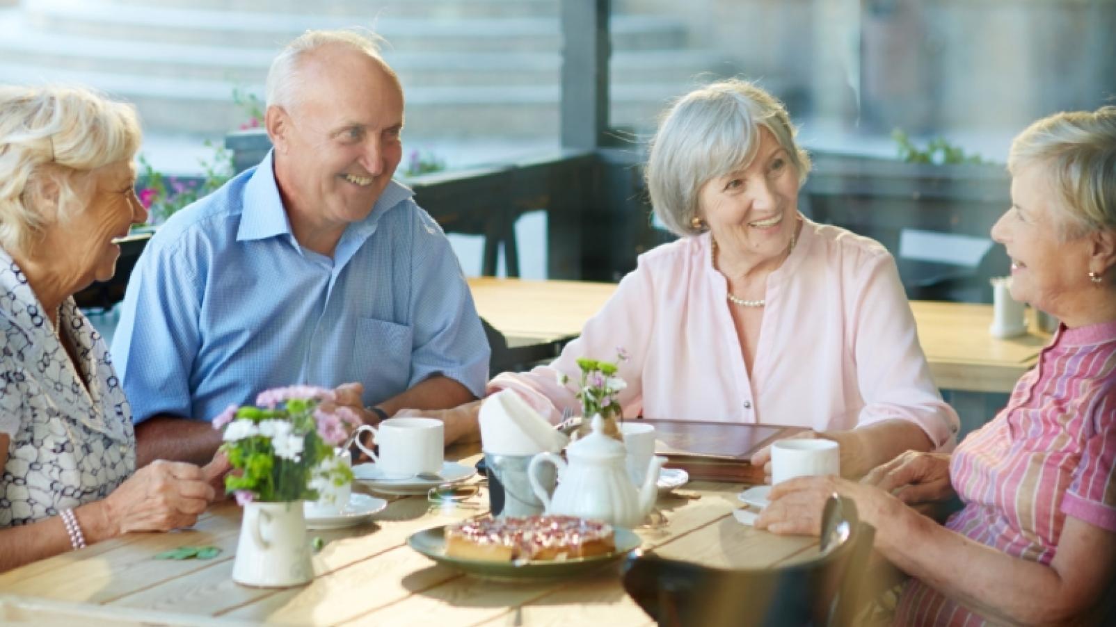 Elderly men and women having lunch
