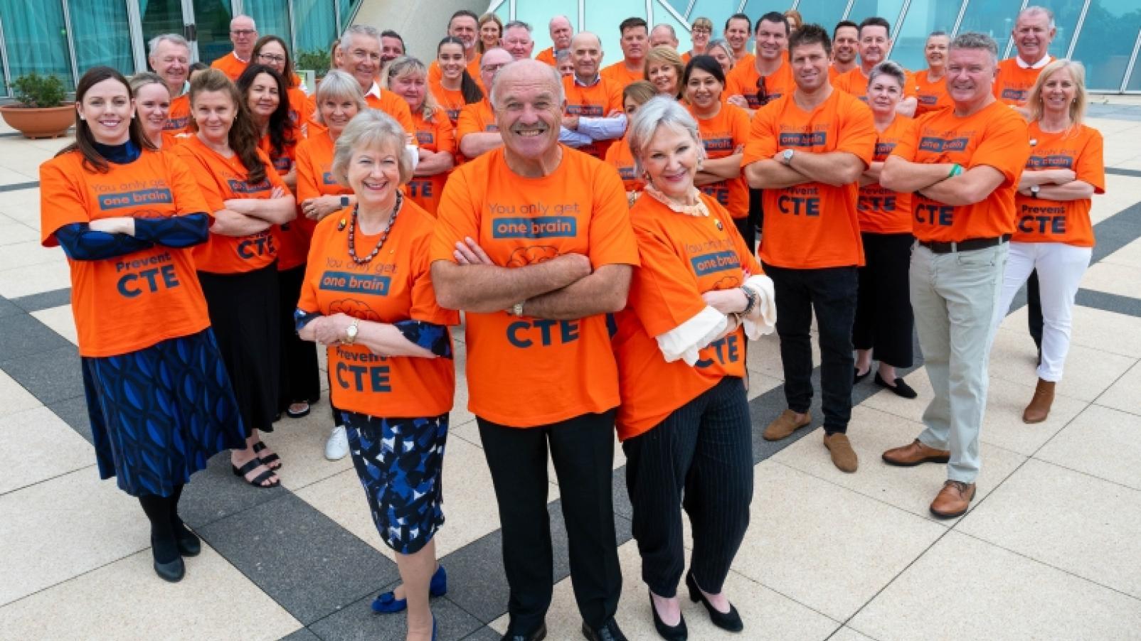Advocates at Parliamentary Friends of Dementia event in February 2024, wearing orange t-shirts to promote CTE awareness.