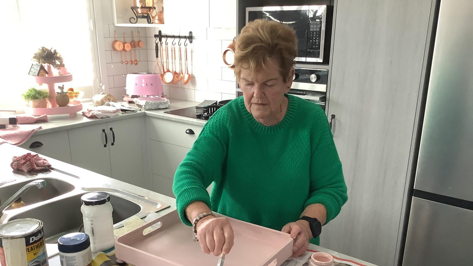 Dementia Advocate Jenny painting a tray.