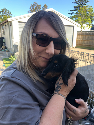 Kris portrait holding a dachshund